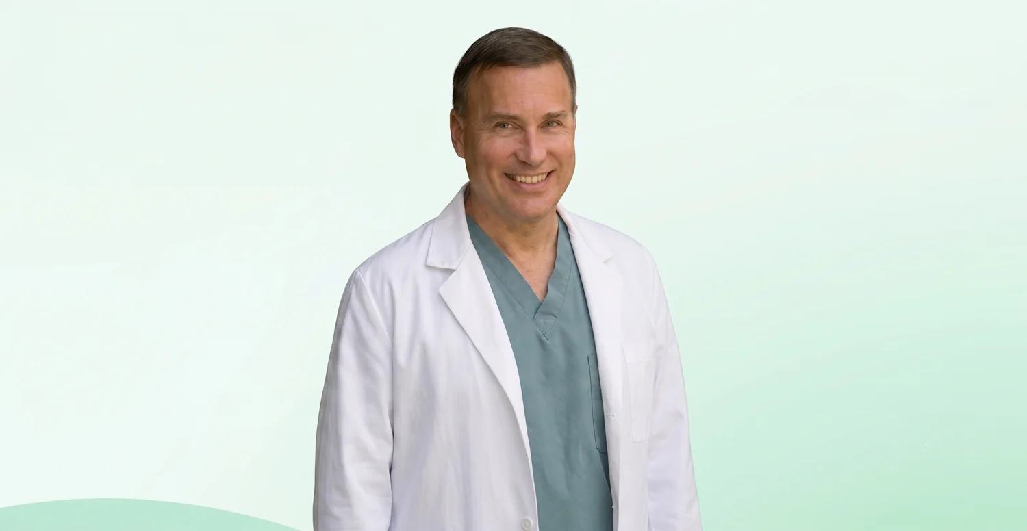 Dr. Jerry Hric, regenerative medicine physician, in his white coat